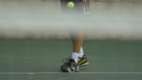 Tennis Player Bouncing Ball on Racket and Knee