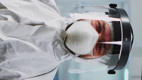 Medical Professional Wearing Protective Suit and Face Shield