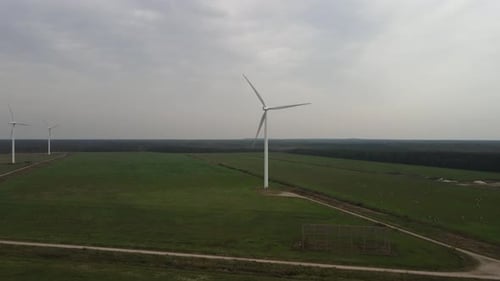 Wind Turbines Rotating in Green Rural Landscape