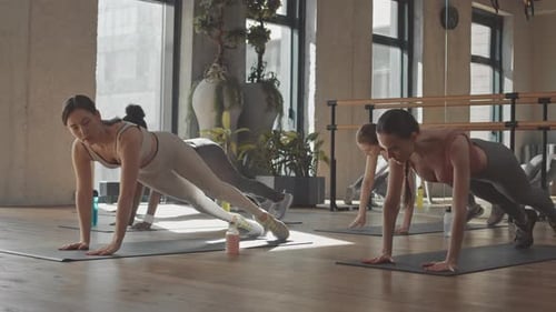 Group of Women Practicing Pilates in Studio