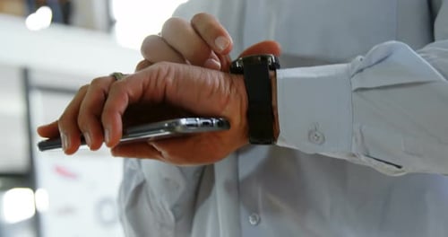 Executive using smartwatch in office 4k