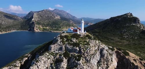 Scenic Lighthouse on Rocky Island Aerial View