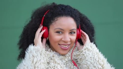 Attractive Woman Listening With Red Headphones Smiling