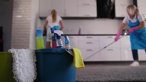 Adults Cleaning a Kitchen Together