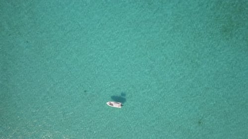 Aerial drone view of a fishing motor boat in the Bahamas, Caribbean.