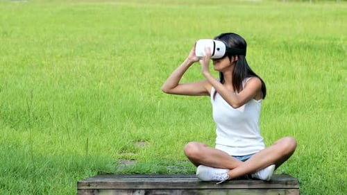 Woman watching with VR device at park