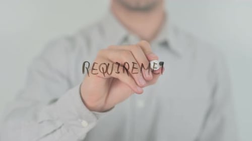 Man Writes Requirement on Clear Surface with Marker