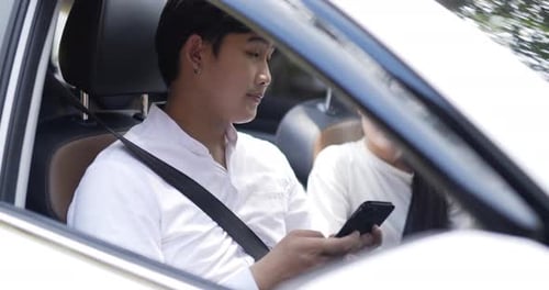 Portrait of couple using mobile phone waiting mechanic man