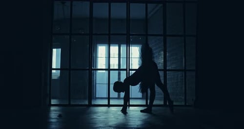 Ballerina Silhouette Stretching in an Urban Setting