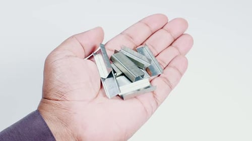 Hand Holds Metal Staples Center