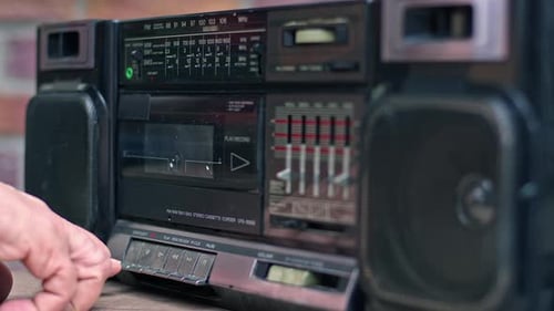 Hand Removing Cassette Tape From Old Boombox