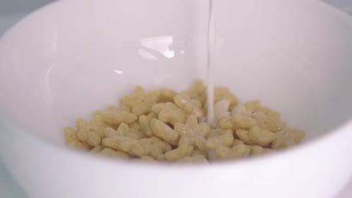 Milk Pouring Into Cereal Bowl Close Up