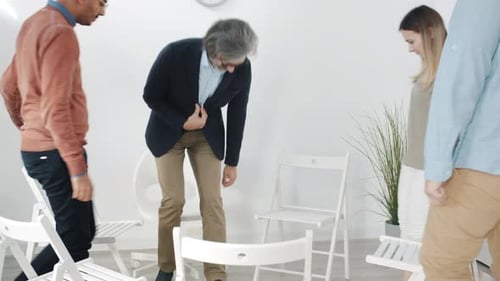 Happy Men and Women Coming to Support Group Meeting Talking Sitting in Circle