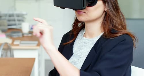 Woman Using VR Headset in Workplace Setting
