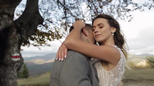 Lovely Young Newlyweds Bride Groom Embracing on Mountain Slope Happy Wedding Couple Family in Love