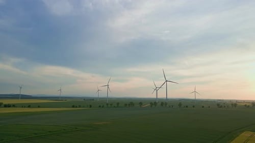 Wind Turbines Spinning in Rural Countryside at Sunset