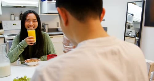 Couple Enjoying Breakfast Together in Sunny Kitchen
