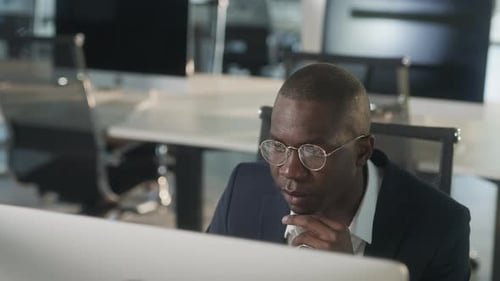 Serious African American Employee Thinking Over Business Email Working on Computer in Office Focused