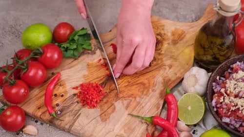 Person Dicing Red Peppers for a Fresh Salsa