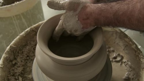 Artisan potier finissant un vase de boue