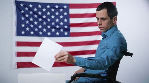 Man in a Wheelchair Voting in an Election