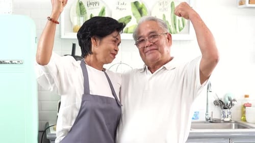 Happy Senior Couple Embracing in Bright Kitchen