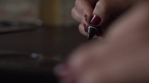 Woman Using Stylus on a Graphics Tablet