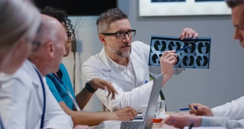 Doctors Analyzing X-Ray During Medical Conference