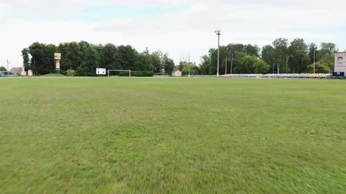 Flight over green grass on soccer field