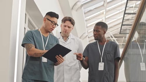 Medical Team Meeting in Bright Hospital Hallway