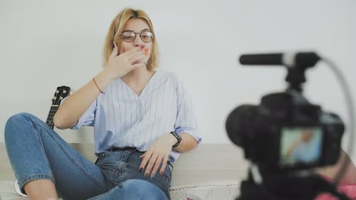 Young Adult Woman Vlogging Indoors to a Camera
