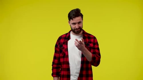 Young Adult Gesturing on Yellow Background