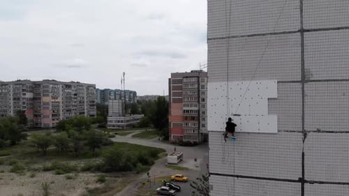 Industrial Alpinism. Aerial View. Work on Outer Insulate Building with Styrofoam