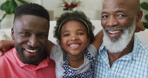 Three Smiling Family Members Embracing Indoors