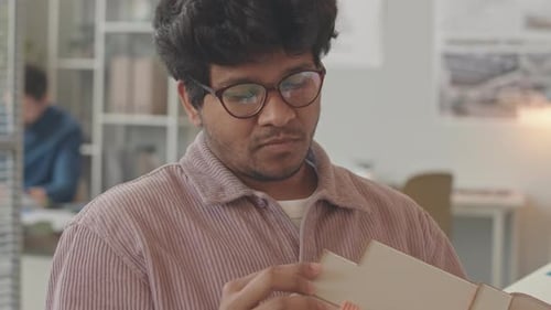 Architect Examining Building Model in Bright Office