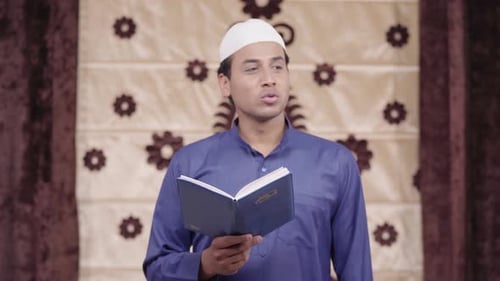 Young Man Reading Holy Book Indoors
