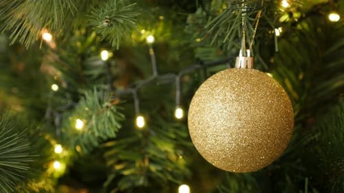 Close Up of Glittering Christmas Ornament on Tree