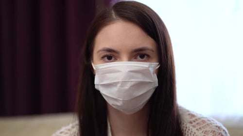 Young Woman Wearing Protective Mask at Home