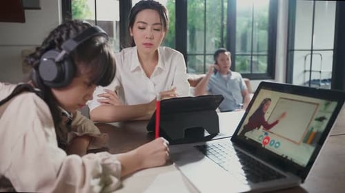 Homeschool Asian little young girl learning online class from school teacher by digital remote class