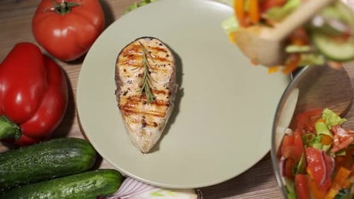 Baked Salmon with Vegetables on a Plate in a Restaurant Closeup Slowmotion Video