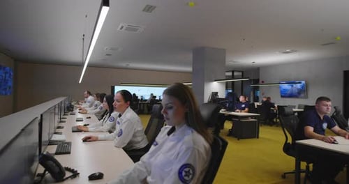 People Working in a Modern Security Surveillance Office