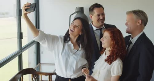 Business Team Smiles For Selfie In Office