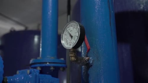 Pressure Gauge on Blue Industrial Pipe
