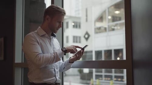 Fair-Haired Man Using Phone Indoors