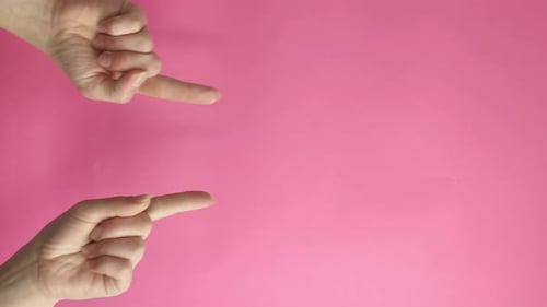 Hands Pointing Fingers at Each Other on Pink