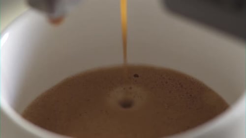 Hot Coffee Pours into White Mug