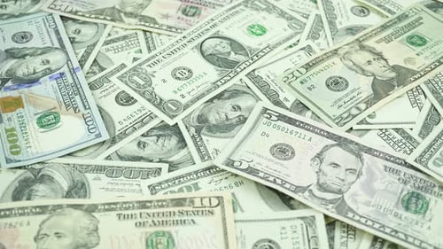 Dollar Bills Of Different Denominations On The Table.