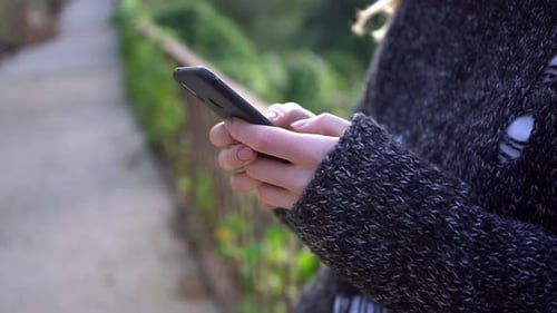 Woman Using Mobile Phone in Urban Setting