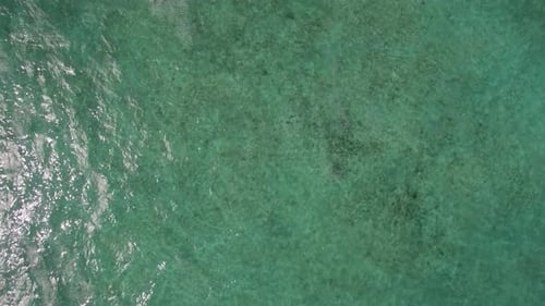 Flying over shallow and deep water of the ocean