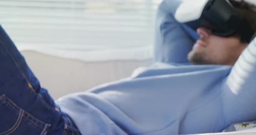 Man Relaxing on Sofa with VR Headset